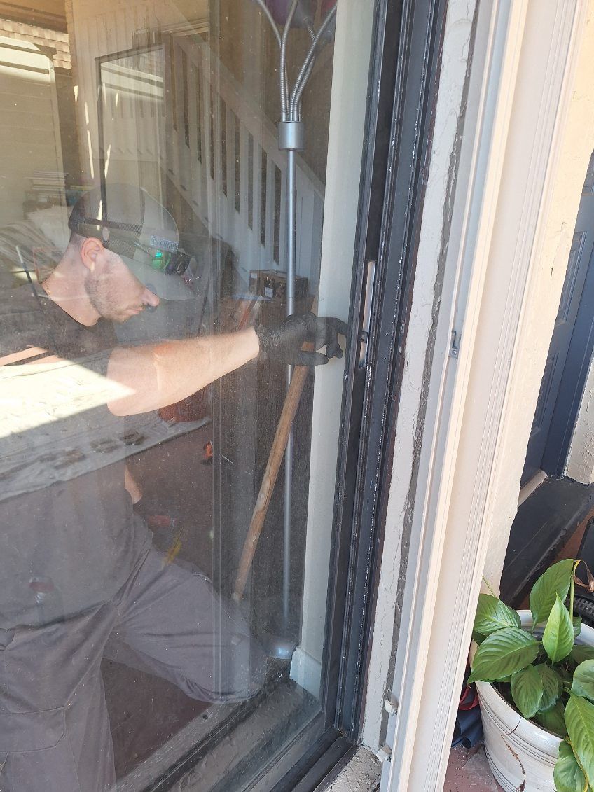 Technician cleaning a newly installed sliding glass door panel — sliding glass door repair in Cocoa Beach, Florida