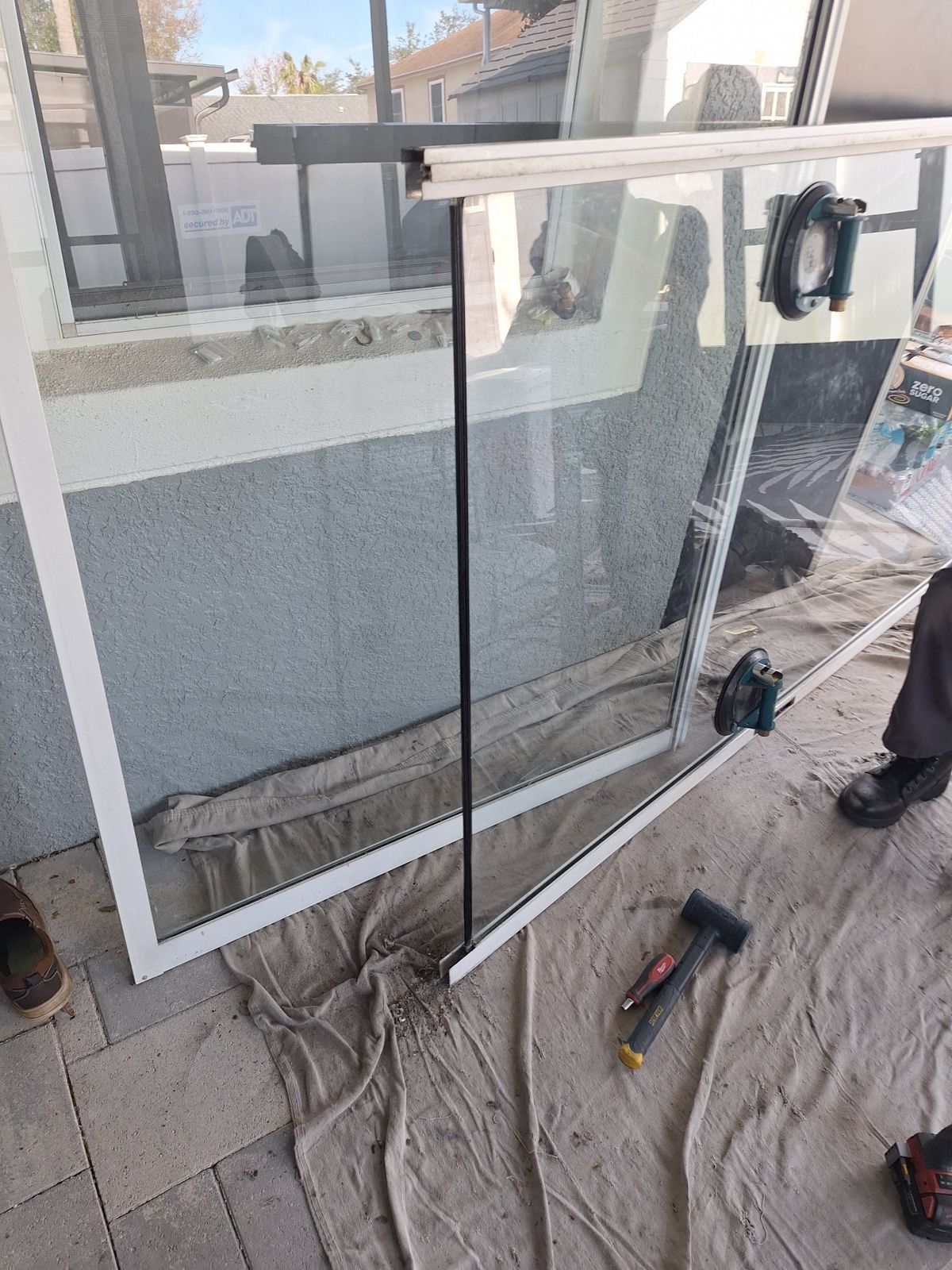 Sliding glass door panel removed and laid out for glass replacement — sliding glass door repair in Apopka, Florida