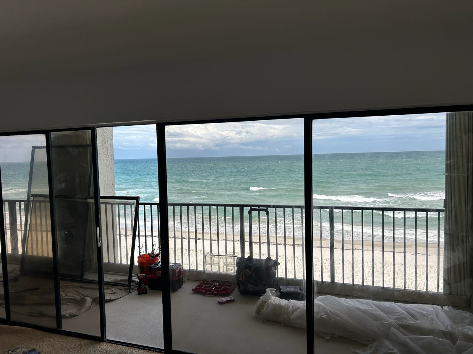 Beachfront sliding glass doors with the ocean beyond the balcony rail — sliding glass door services in Indian Harbour Beach, Florida