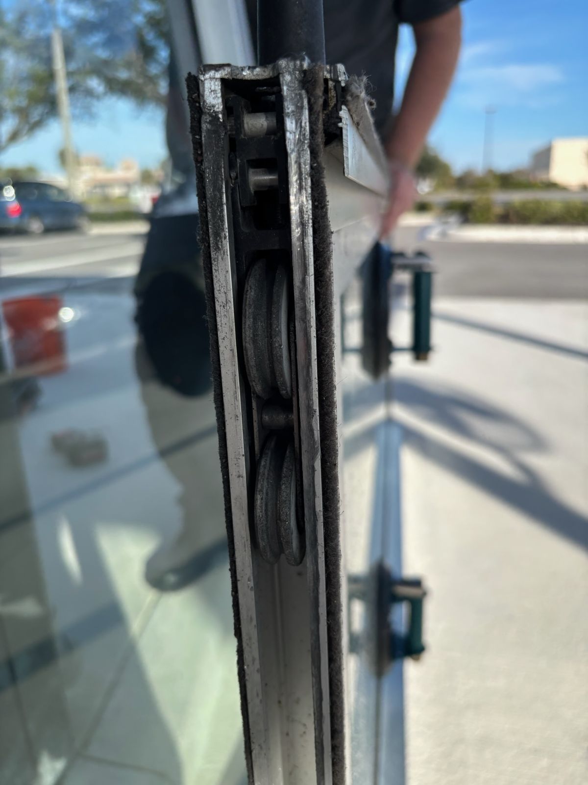 Close-up of a corroded sliding glass door frame edge — sliding glass door repair in Four Corners, Florida