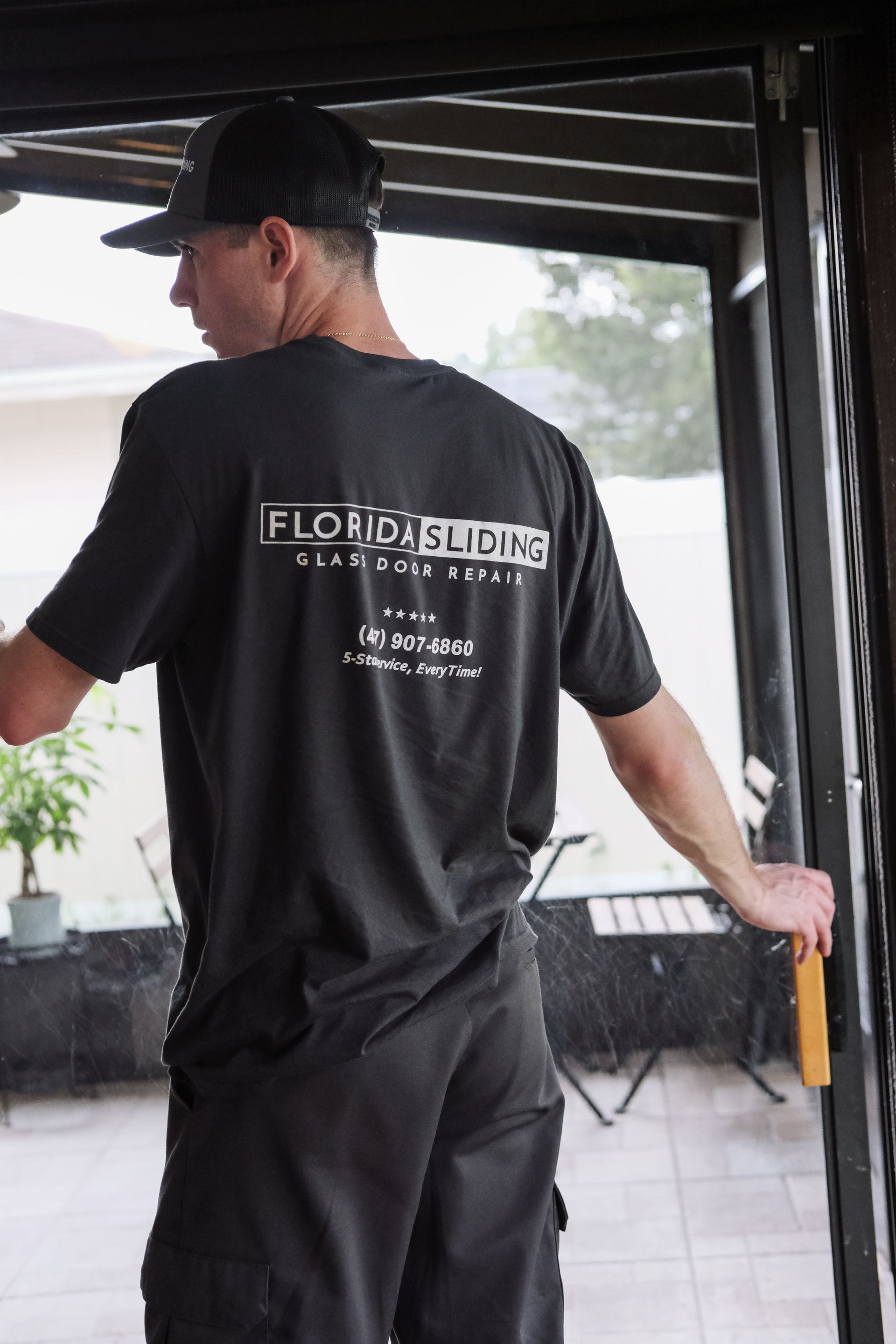 Florida Sliding Glass Door Repair technician servicing a patio door