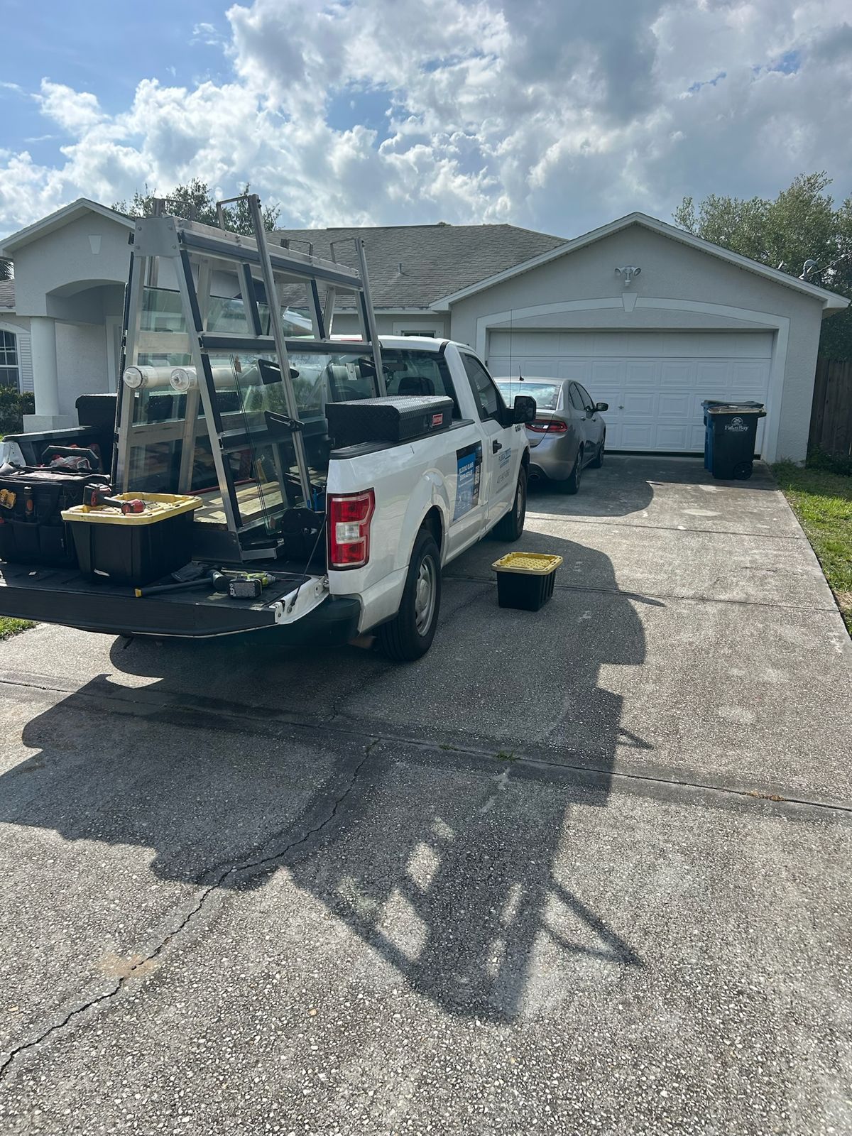 Service truck loaded with replacement sliding door glass outside a Florida home — sliding glass door services in Ocala, Florida